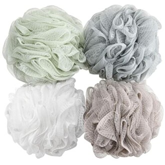 Set of four bath loofahs in pastel colors.