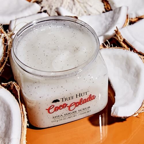 Coco Colada shea sugar scrub surrounded by coconut pieces