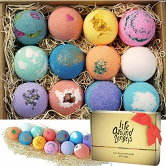 A set of colorful bath bombs in a box with hay, branded packaging.