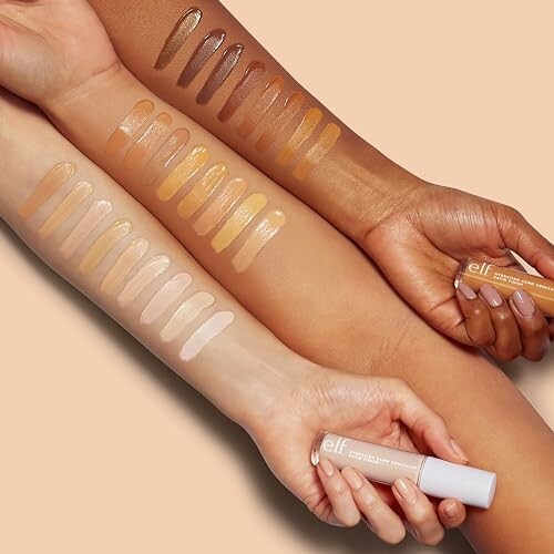 Arms showing concealer swatches in various skin tones.