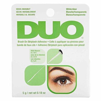 DUO eyelash adhesive packaging with brush applicator and eye illustration.