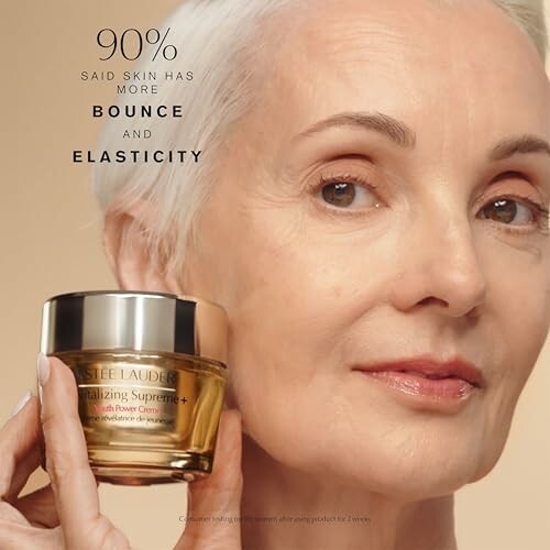 Woman holding Estee Lauder Revitalizing Supreme cream.