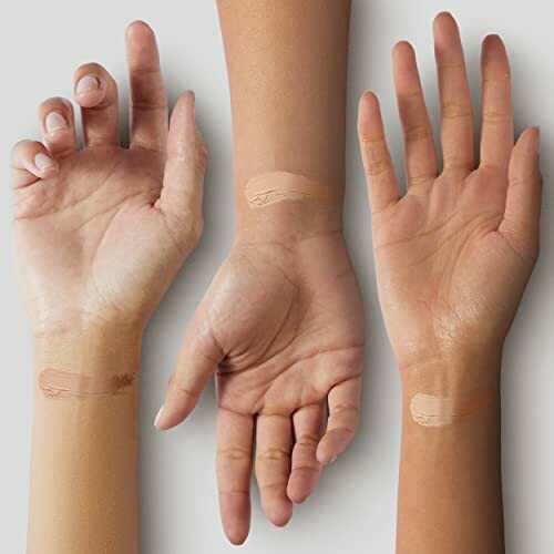 Three hands with different skin tones showing foundation swatches.