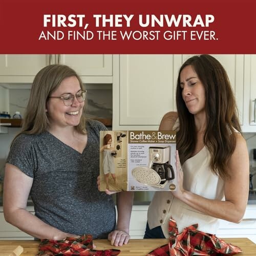 Two women laughing at a humorous coffee maker gift in a kitchen.