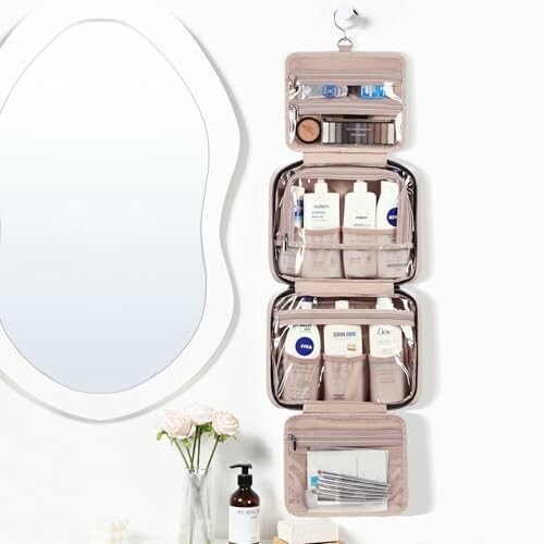 Hanging toiletry bag with various personal care items next to a mirror.