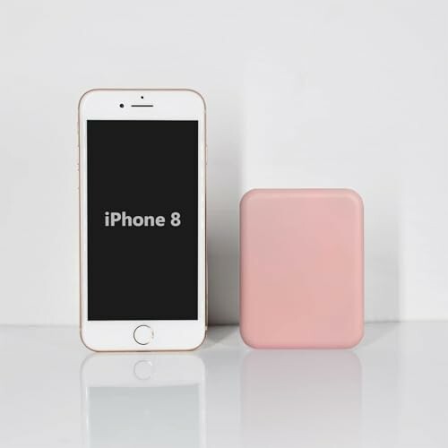 iPhone 8 next to a pink power bank