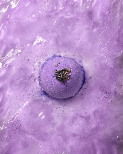 Purple bath bomb dissolving in water