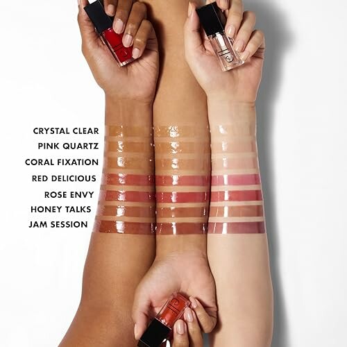 Various shades of lip gloss swatched on three arms with bottles.