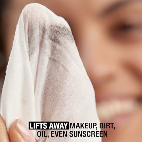 Close-up of a makeup removal wipe lifting away dirt and oil.