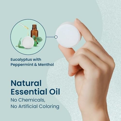 Hand holding natural essential oil product with eucalyptus, peppermint, and menthol.