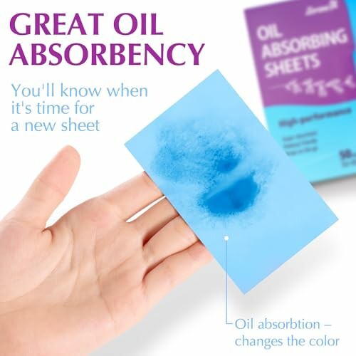 Hand holding an oil absorbing sheet with color change demonstration.