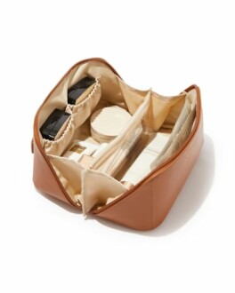 Open makeup bag with cosmetics and compartments