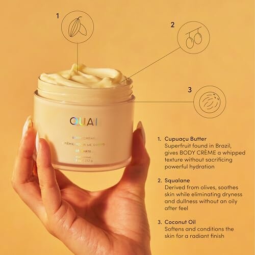 Hand holding Ouai body cream with ingredients listed.