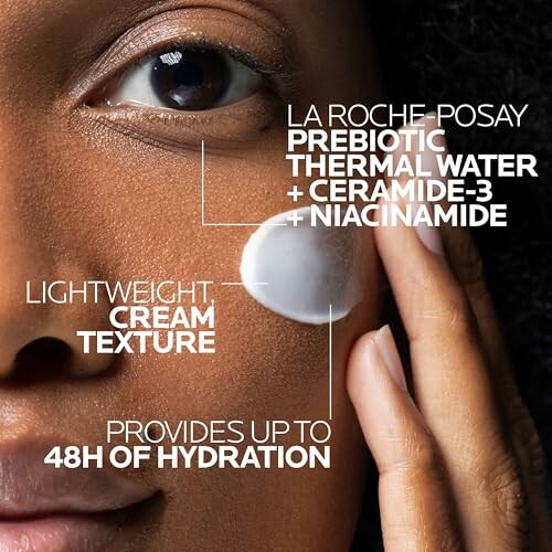 Close-up of person applying skincare cream with product details.