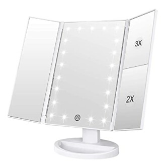 Tri-fold vanity mirror with LED lights and magnification.