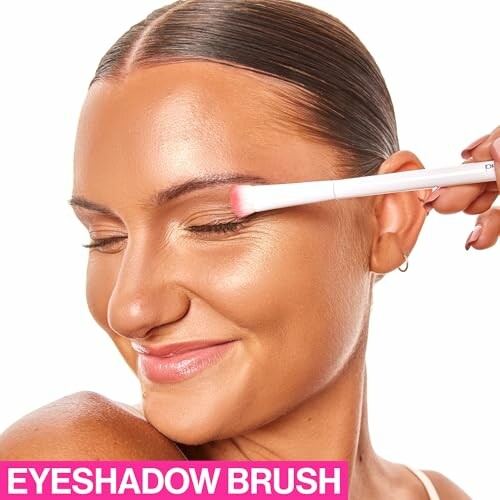 Woman using an eyeshadow brush on eyelid