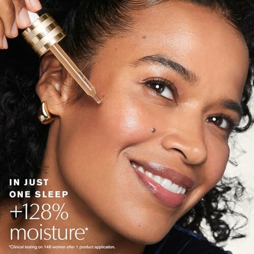 Woman smiling and applying skincare serum to her face with a dropper.