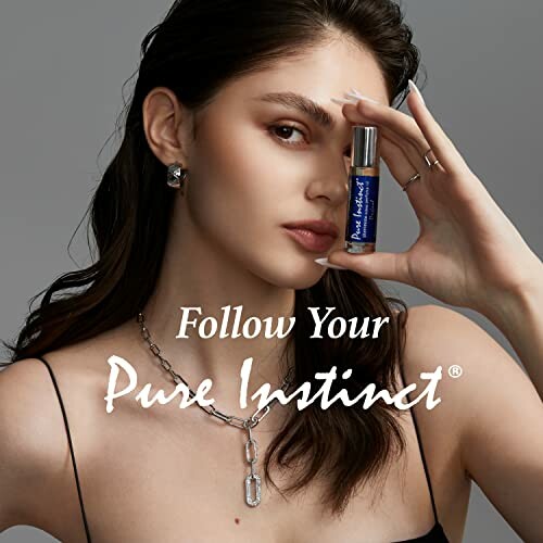 Woman holding a Pure Instinct perfume bottle